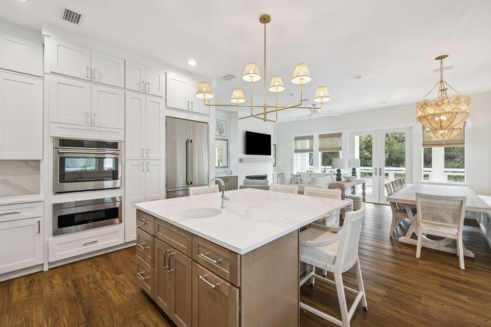 Your spacious kitchen features premium appliances, a marble island for gathering, and elegant lighting that creates the perfect ambiance for cooking and dining together.