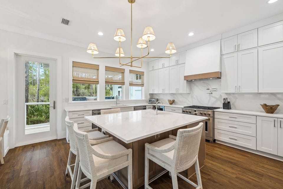 Your spacious kitchen features gleaming white cabinetry, marble countertops, and a large island where you'll love gathering for meals and conversation.