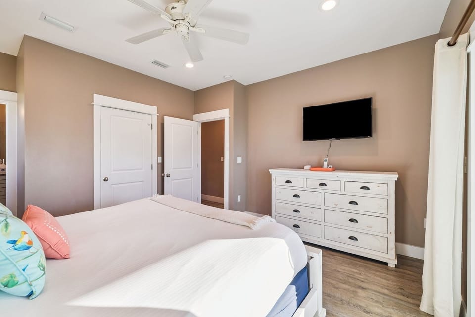 Unwind in your peaceful bedroom with fresh linens, coastal touches, and entertainment at your fingertips.
