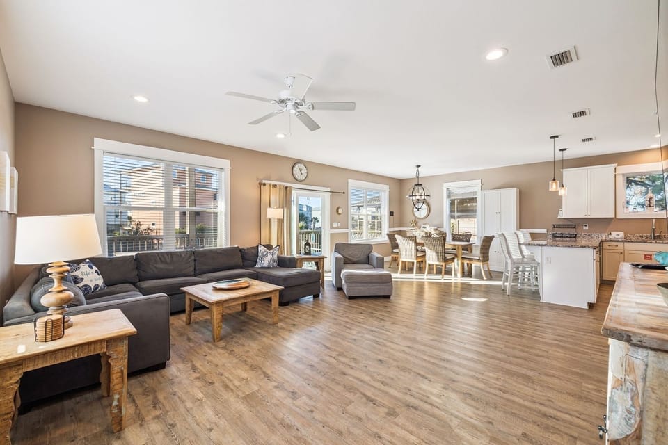 Relax in this spacious open-concept living area where your family can gather on the plush sectional while meals are prepared in the fully-equipped kitchen nearby.