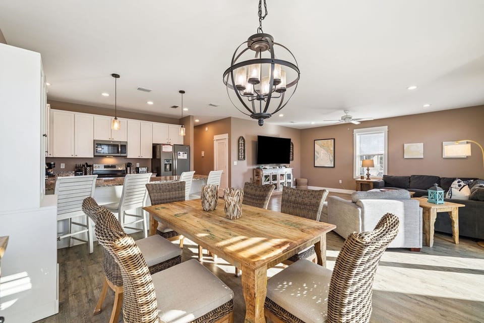 Gather around your spacious dining table where warm light filters through, creating the perfect setting for memorable meals together.