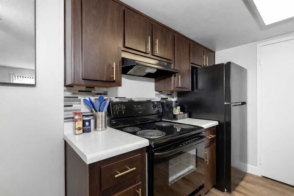 Functional kitchen with oven, stove, fridge and basic cooking ware