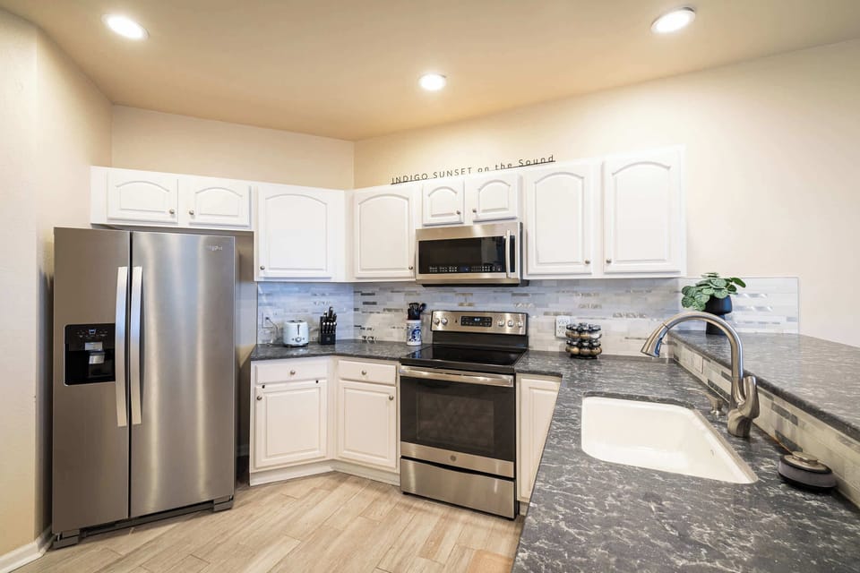 Main Level Fully Equipped Kitchen with Refrigerator, Stove, Oven, Microwave, Coffee Maker, Dishwasher, and Breakfast Nook