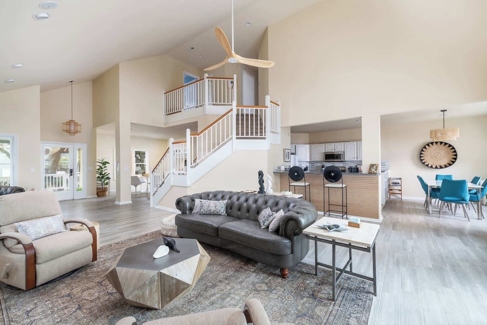 Main Level Open Layout Featuring Connected Living, Dining, and Kitchen Areas