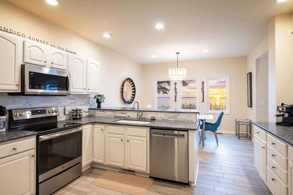 Main Level Fully Equipped Kitchen with Refrigerator, Stove, Oven, Microwave, Coffee Maker, Dishwasher, and Breakfast Nook