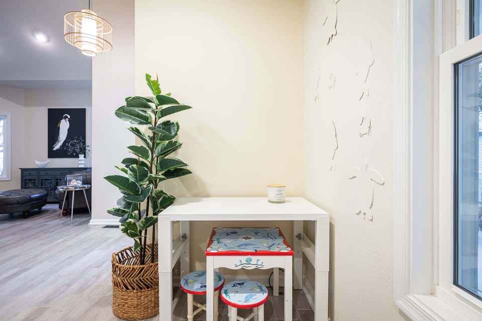 Main Level Kids' Activity Corner with a Child Sized Table and Chairs, Providing a Dedicated Space for Games, Crafts, Coloring, and Creative Play