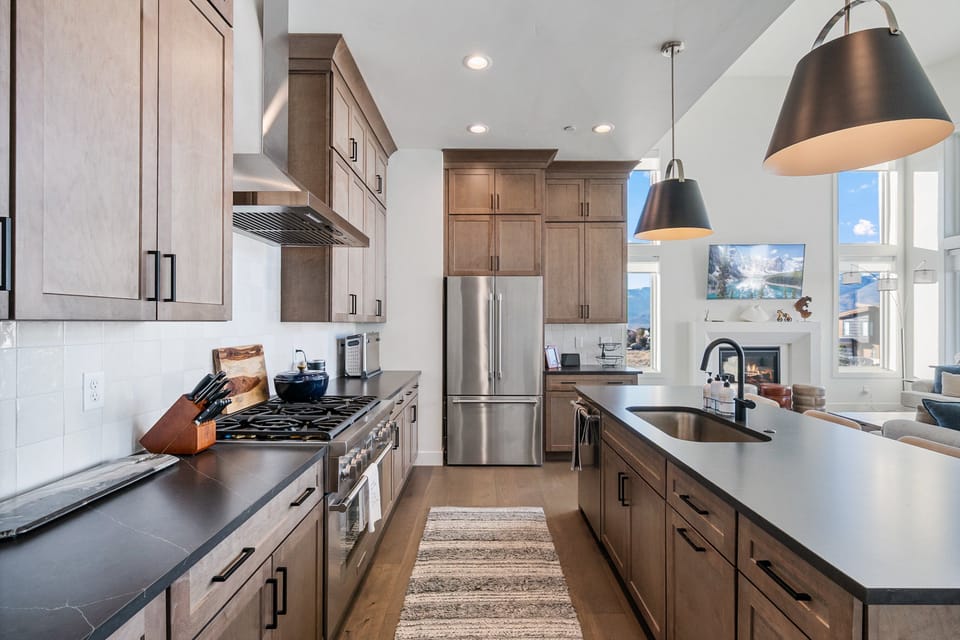 A professional Gas range and high end stainless steel appliances in this well stocked kitchen