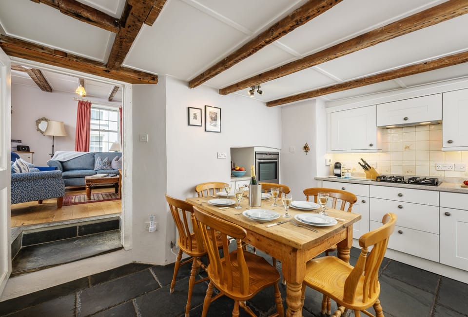 Hardys, Padstow. Ground Floor: Kitchen with an electric oven, gas hob, microwave, fridge, dishwasher, and Nespresso coffee machine