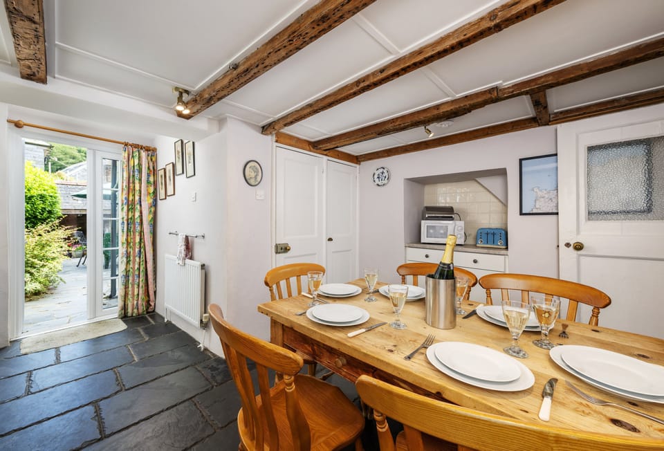 Hardys, Padstow. Ground Floor: Kitchen with an electric oven, gas hob, microwave, fridge, dishwasher, and Nespresso coffee machine