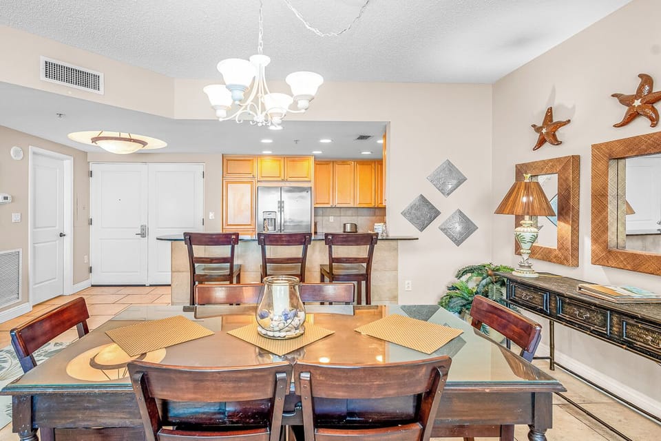 Gather around your elegant dining table while the fully equipped kitchen awaits your culinary adventures in this beautifully appointed space.