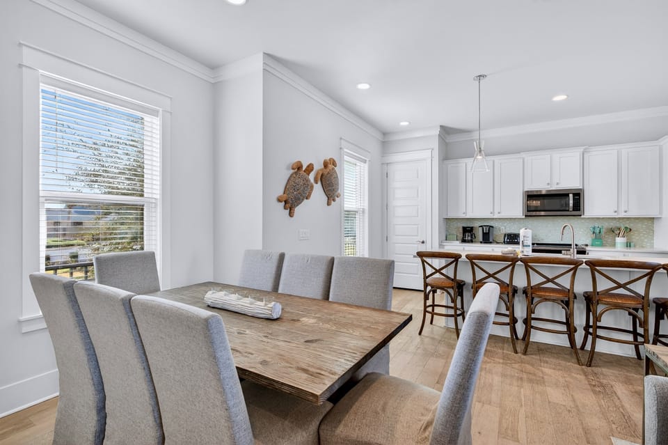 2nd Floor - Inviting dining room with generous seating, perfect for family meals, celebrations, and gathering together after a day at the beach. Conveniently located next to the kitchen for easy serving and entertaining.
