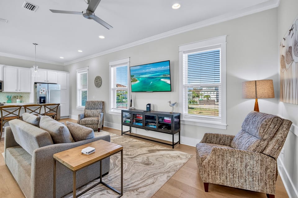 2nd Floor - Spacious Great Room with open-concept living, comfortable lounge seating, and a large 4K Smart TV—perfect for relaxing after the beach, movie nights, and gathering with family and friends.