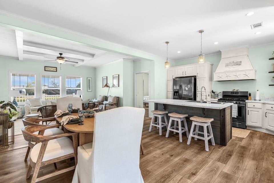 Gather around your spacious kitchen island or unwind in the bright living area where ocean breezes flow through.