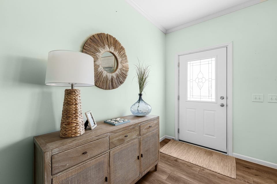 Step into your welcoming entryway, where coastal charm meets comfort with warm wood tones and thoughtful touches that instantly make you feel at home.