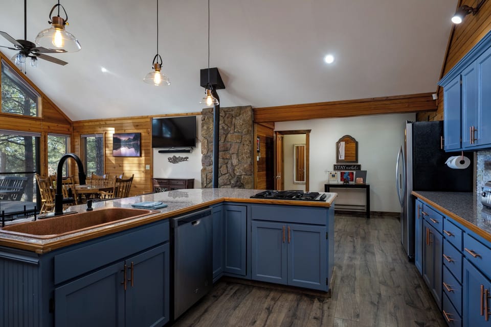 Your fully-equipped kitchen invites culinary adventures with granite counters, stainless appliances, and warm wood accents creating the perfect gathering space.