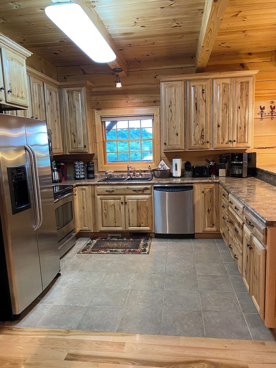 The kitchen has high-quality appliances (refrigerator/freezer, range, microwave, dishwasher, 2 coffee makers (Keurig,Drip), high-quality Hickory cabinets, lots of cabinet space (supplemented with more cabinets in the dining area) and a window to the lake. 