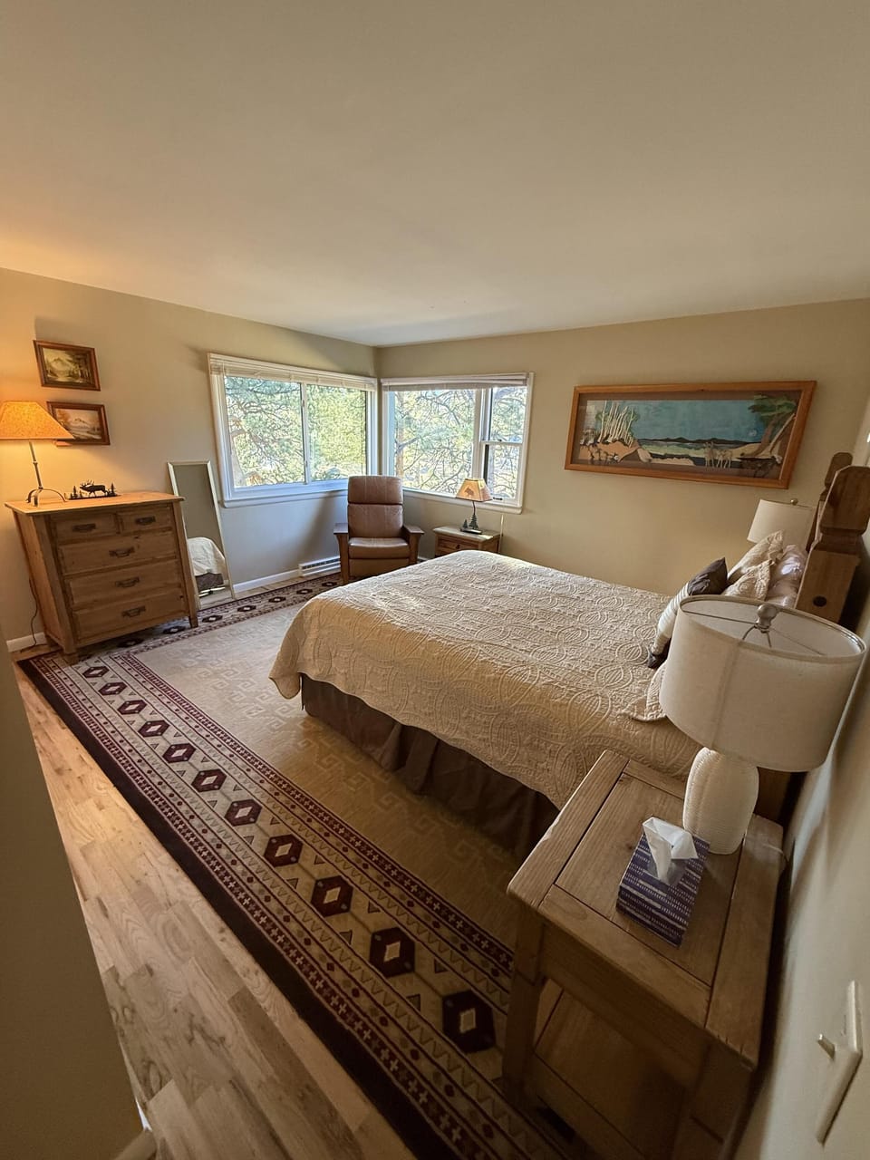 Cozy bedroom retreat with scenic window views and warm lighting