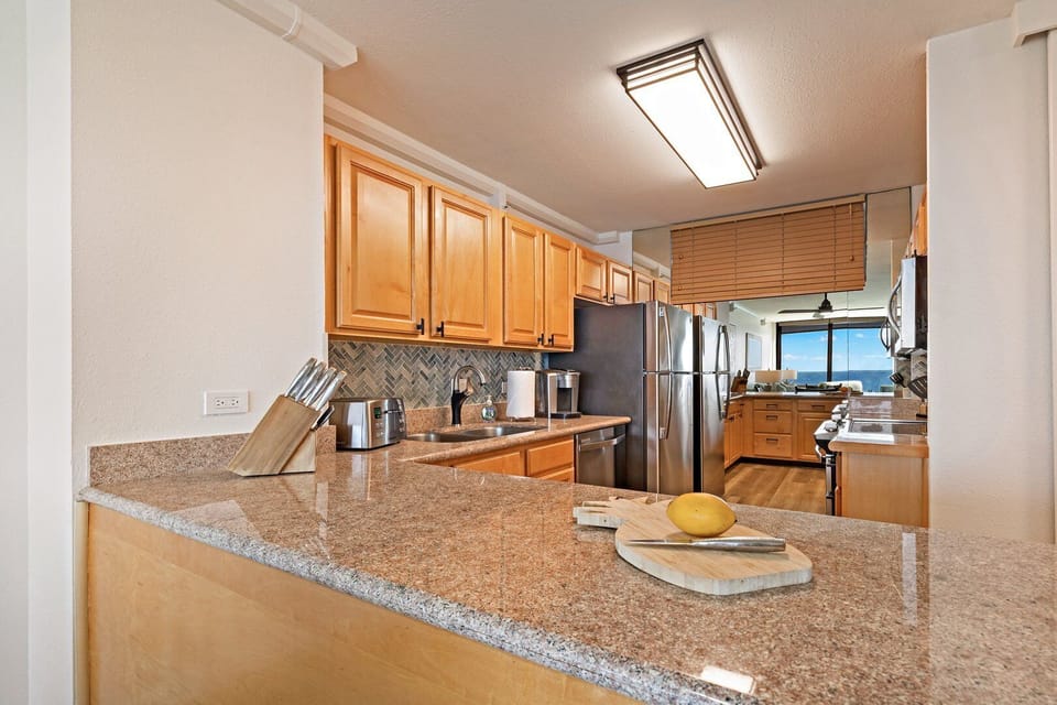 Fully equipped kitchen offering breathtaking ocean views while you cook your favorite meals