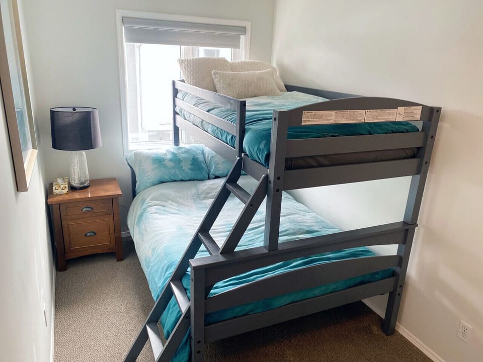 Bunk bed features a spacious double mattress on the bottom and a cozy single mattress on top