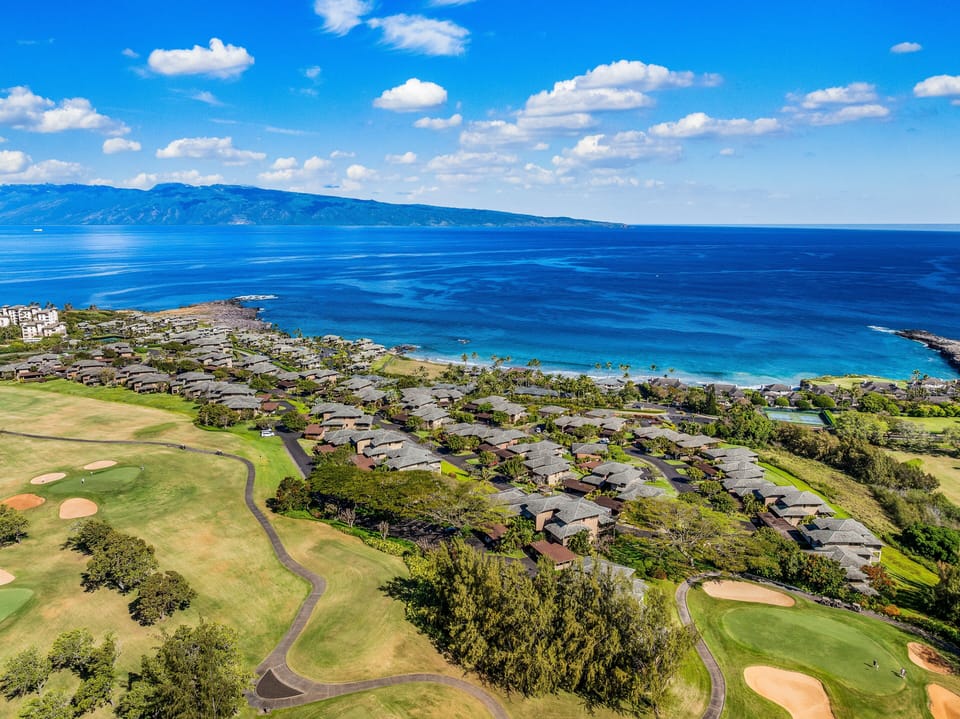 Breathtaking aerial view showcasing lush golf courses and sparkling blue ocean waters