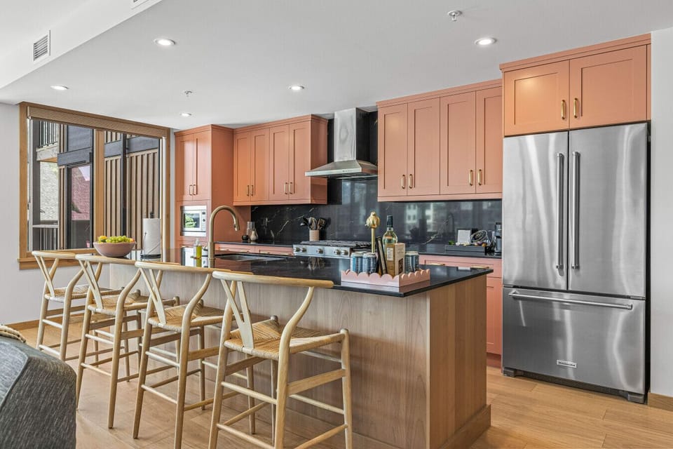 The oversized kitchen island creates a social setting and provides additional seating for 4 guests