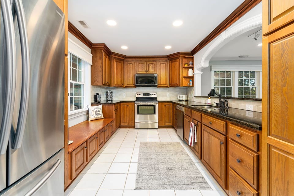 Whip up culinary delights in this inviting, sunlit kitchen with ample storage!