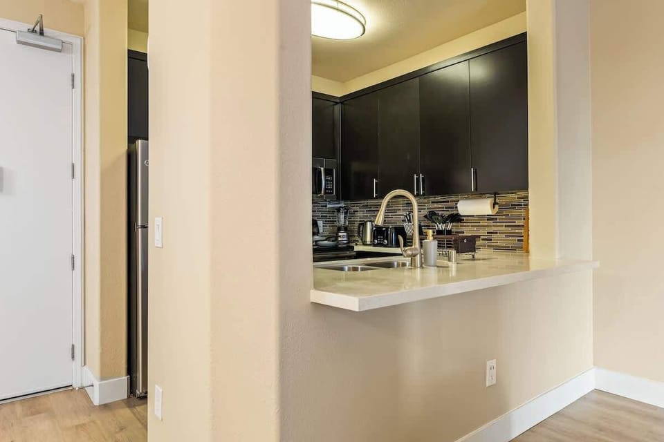 Modern full kitchen with stainless steel appliances, plenty of storage, and all essentials for cooking.