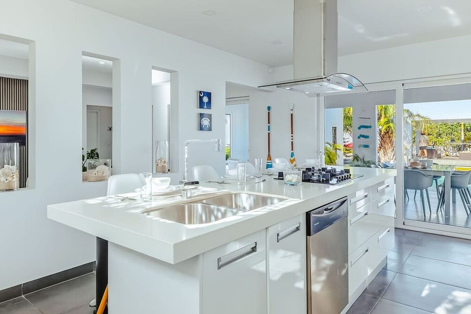 A clean, modern kitchen with a spacious island and everything you need for easy, comfortable cooking and shared meals.
