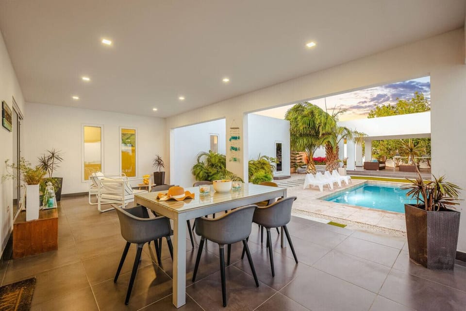An open-air dining area by the pool—perfect for shared meals, evening chats, and enjoying the breeze in a relaxed, laid-back setting.