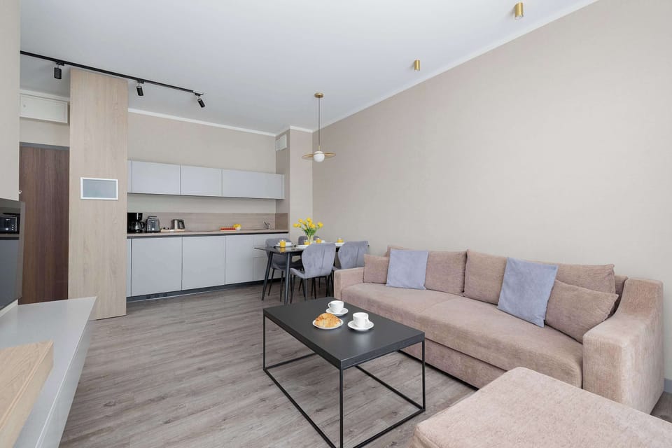 Another angle of the living room showing the sofa and coffee table. The layout encourages comfortable shared moments.