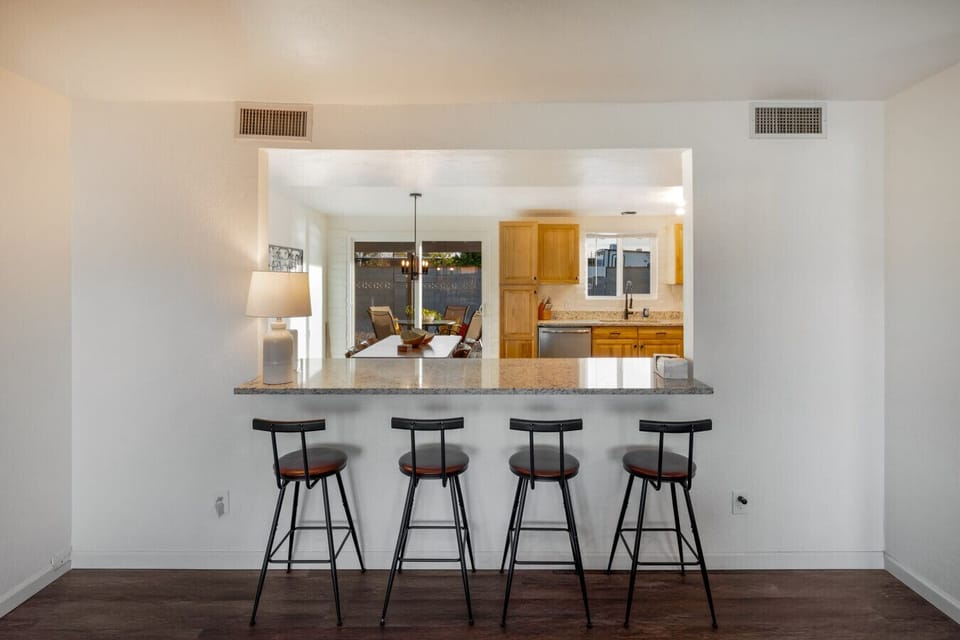 Additional seating at the bar area between the living room and kitchen