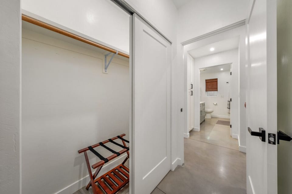 View of Bedroom 2`s closet and the guest bathroom across the hall