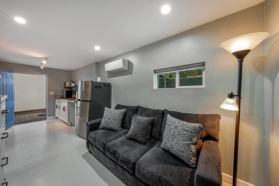 Cozy living room area next to the kitchenette with comfortable couch and storage space