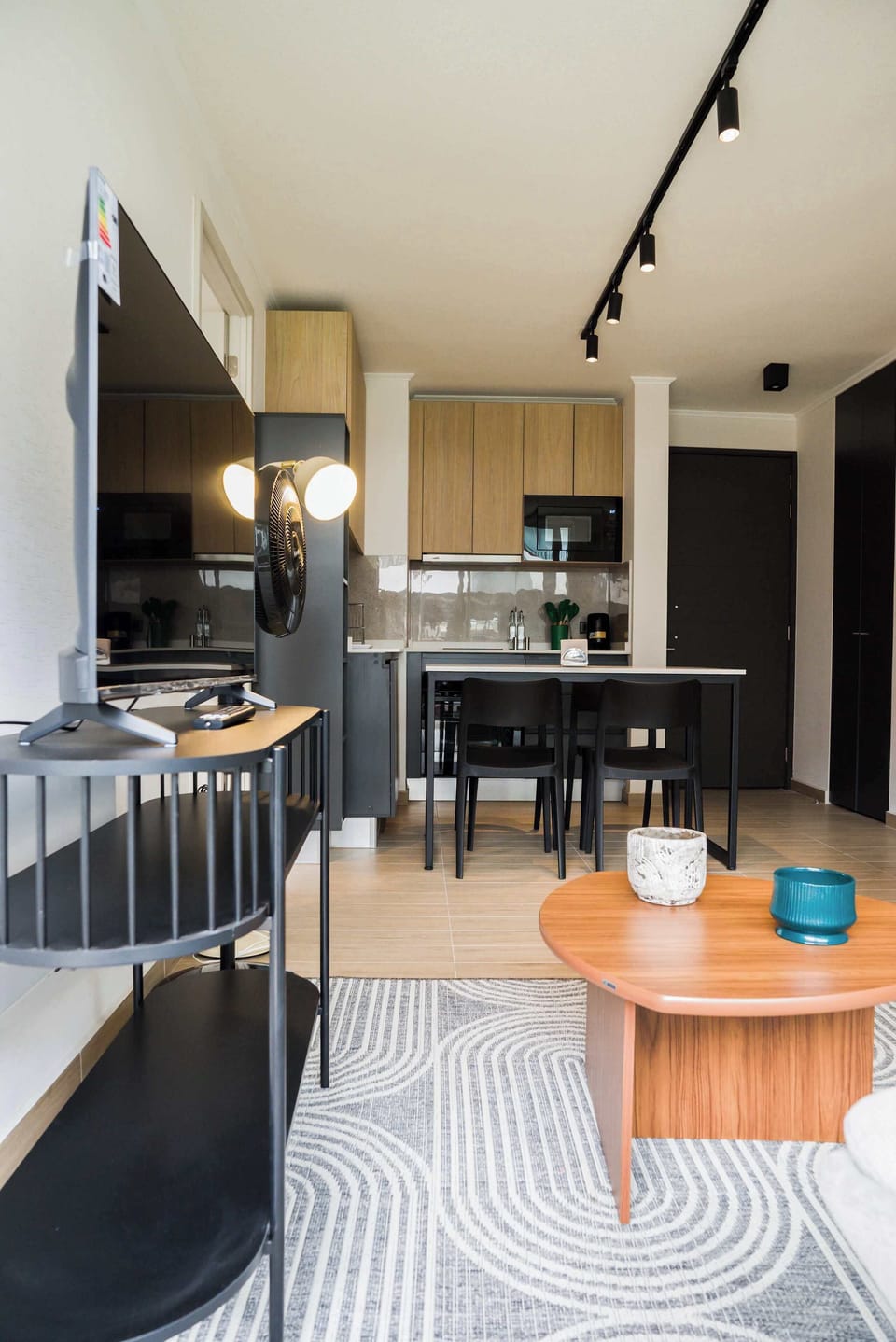 Cozy and modern living area with a sleek kitchenette, perfect for relaxing after a day of exploring.