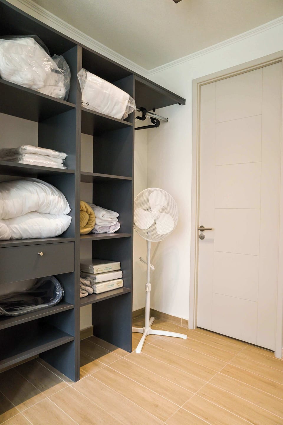 Spacious closet with fresh linens and towels, ensuring a comfortable stay.