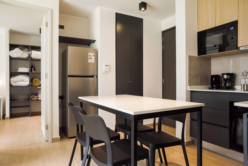 Sleek kitchen with modern appliances and ample storage, perfect for cooking and dining.