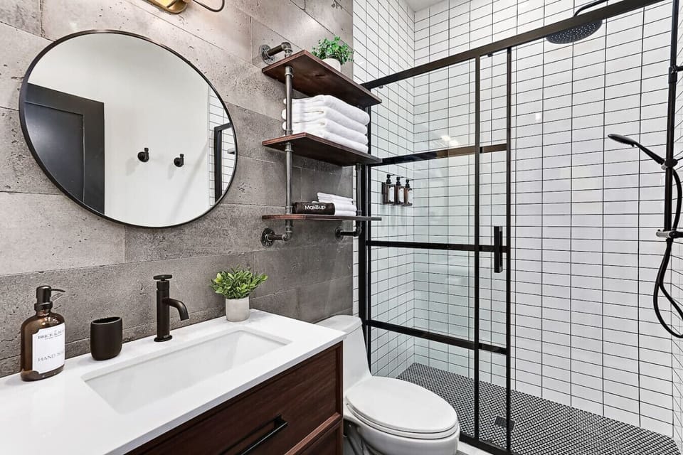 A clean, modern bathroom with bright lighting, fresh towels, and a walk-in shower to help you refresh during your stay.