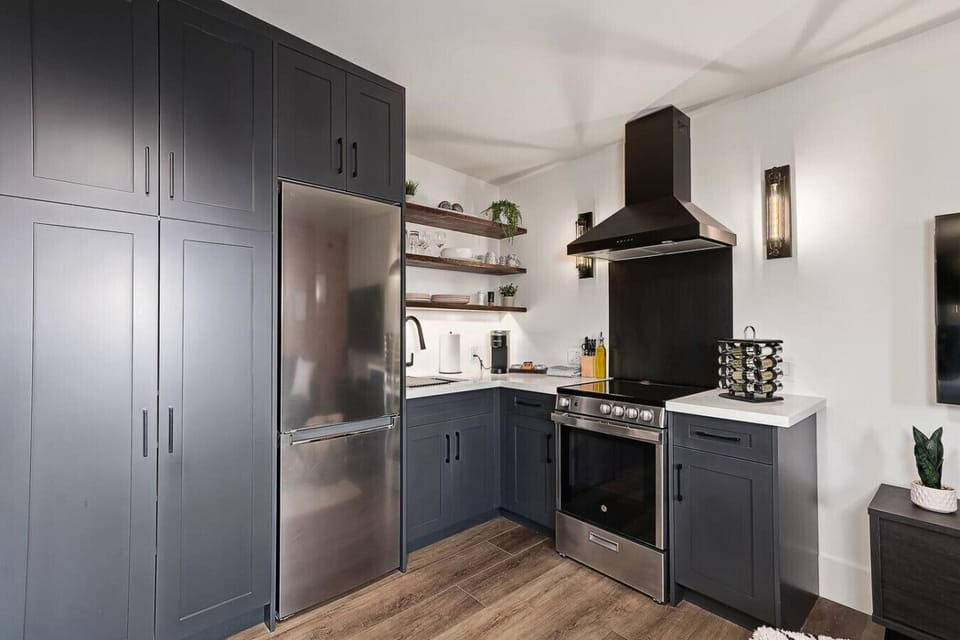 A modern kitchen fully equipped with stainless steel appliances, cooking essentials, and plenty of counter space for preparing meals during your stay.