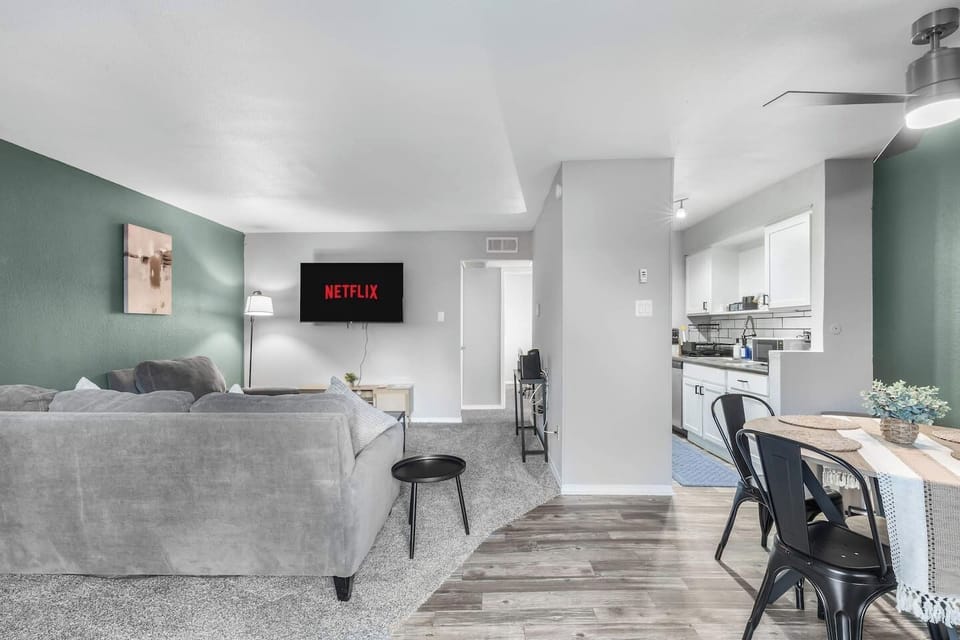 Spacious and inviting living area with comfortable seating and a smart TV, perfect for relaxing after exploring Arlington or attending events at AT&T Stadium.