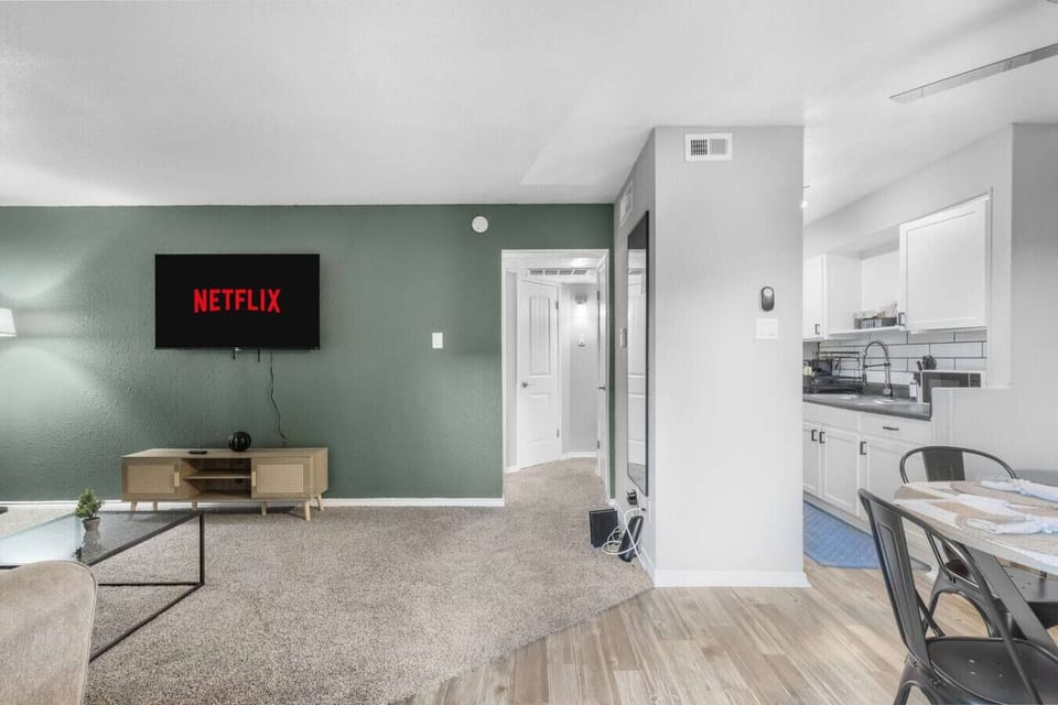 Spacious and inviting living area with comfortable seating and a smart TV, perfect for relaxing after exploring Arlington or attending events at AT&T Stadium.