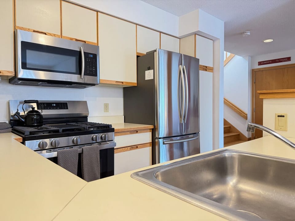 Prepare your favorite meals in this modern kitchen with stainless steel appliances.