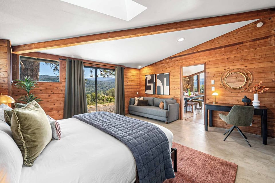 Spacious primary bedroom with a king bed and luxury linens. The sleeper sofa folds out to a queen bed.
