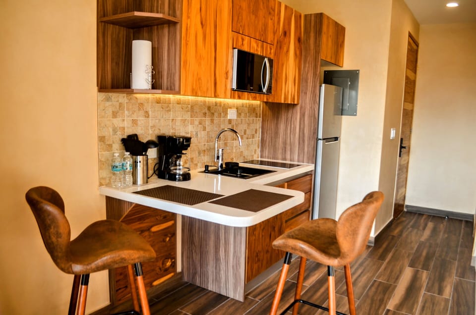 Deluxe Apartment, Partial Sea View | Private kitchen | Coffee/tea maker, fridge, microwave, stovetop