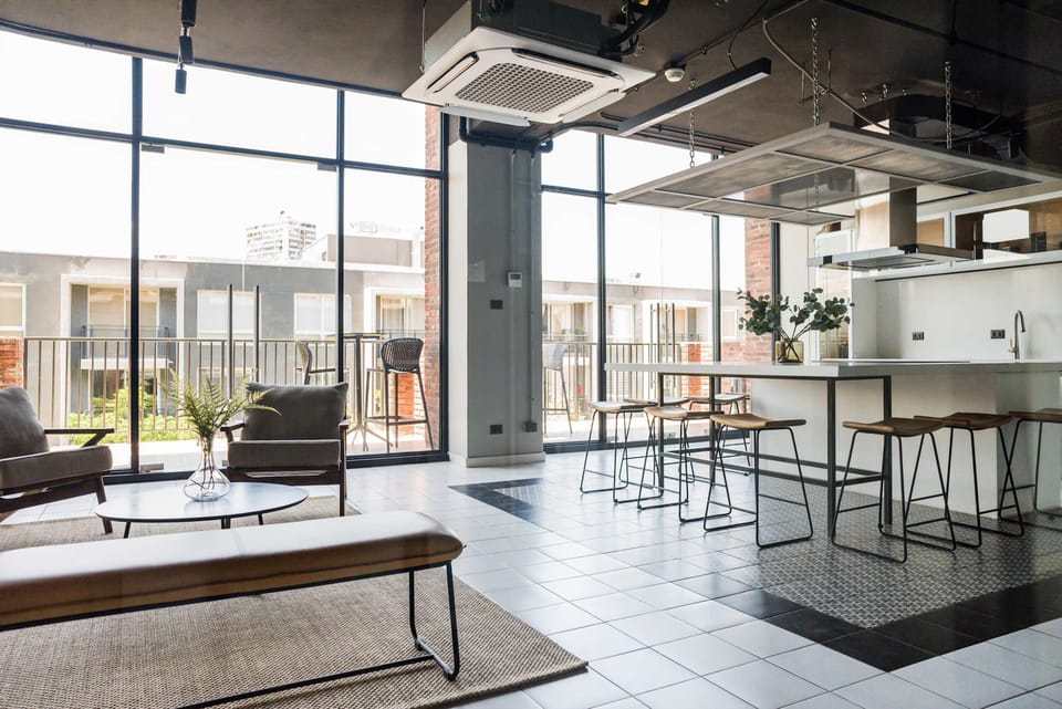 Relax in a stylish, sunlit lounge with modern seating and expansive views, ideal for socializing or unwinding.