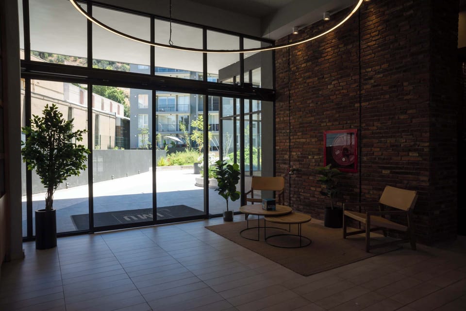 Modern lobby with natural light and cozy seating, ideal for a relaxing break. (Common Area)
