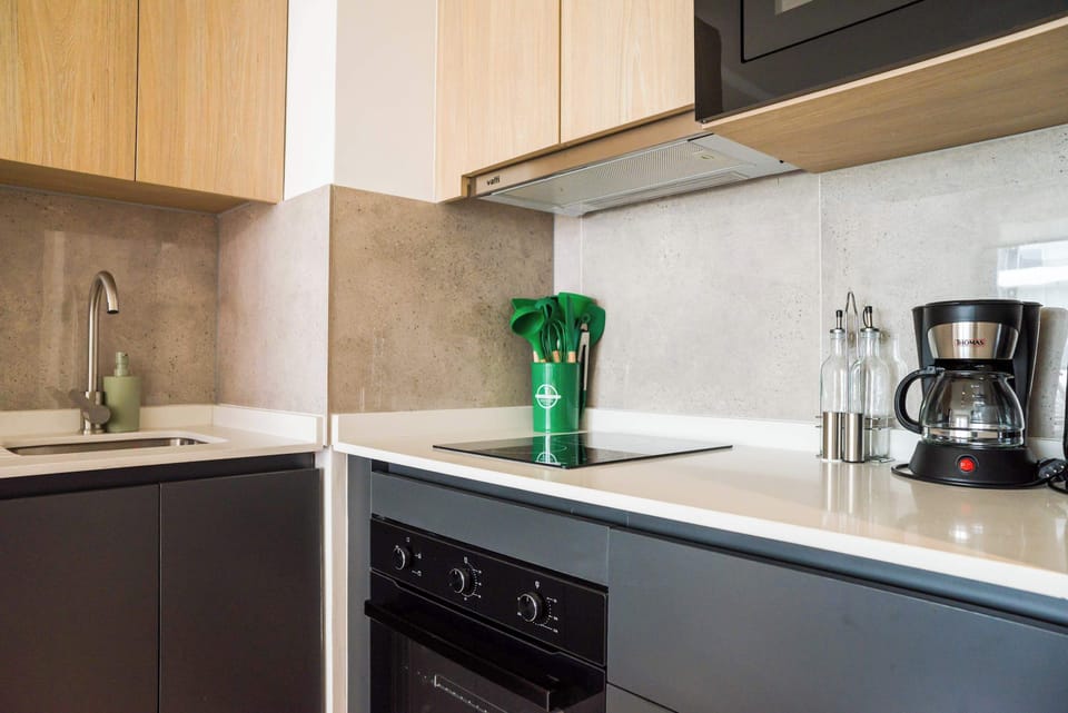 Modern kitchen with sleek appliances and stylish finishes, perfect for culinary creations.