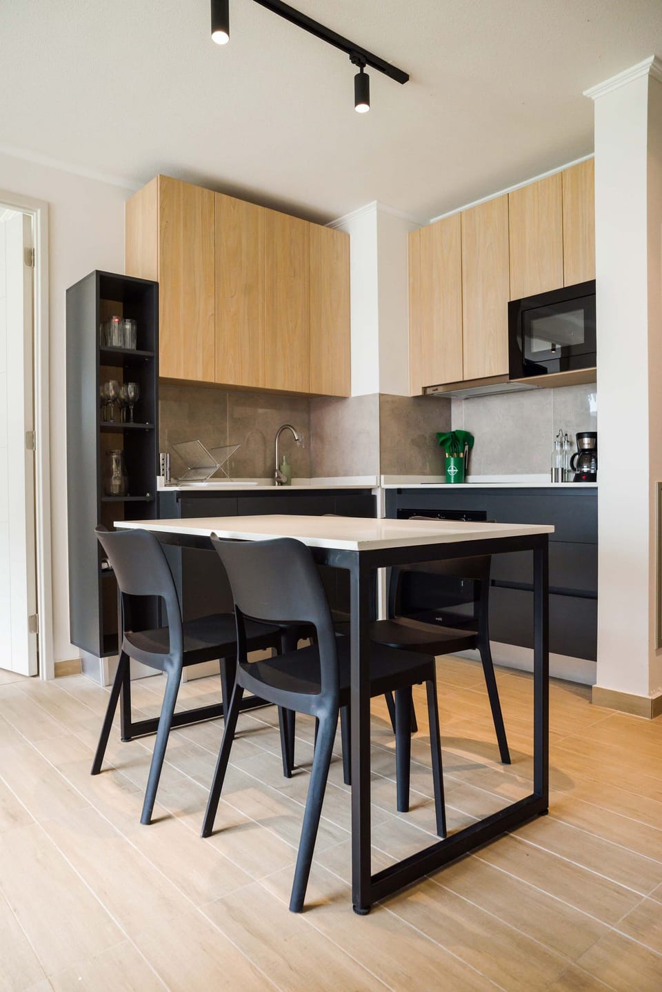 Modern kitchen with sleek dining area, ideal for cozy meals and gatherings.