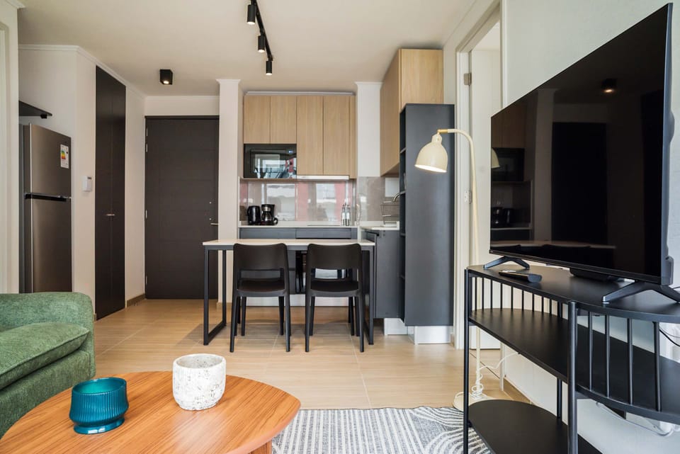 Cozy and modern living space with a sleek kitchen and entertainment area, perfect for relaxing after exploring the city.