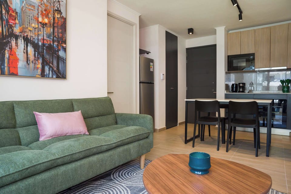 Cozy living area with modern kitchen and vibrant decor, perfect for relaxation and dining.