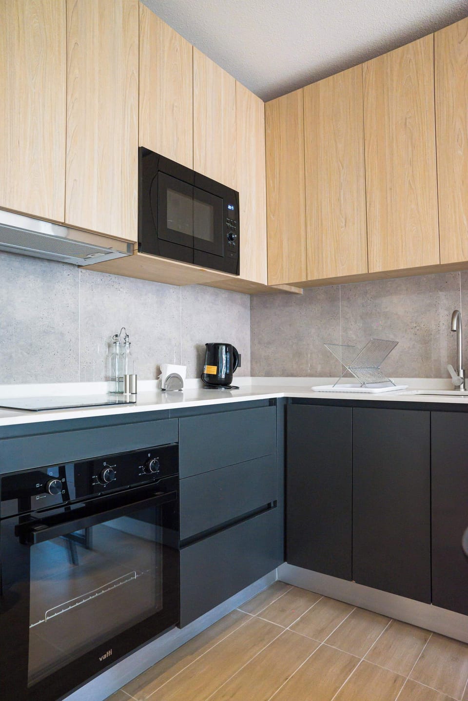 Sleek and modern kitchen equipped with essential appliances for a comfortable stay.